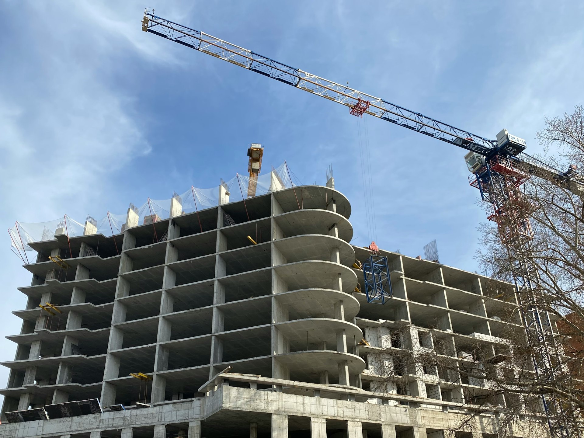 a crane is on top of a building under construction
